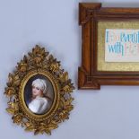 A Continental oval painted porcelain plaque in Florentine frame, height 6.5" overall, and a carved