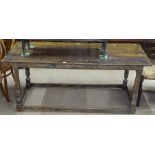 An Antique oak serving table, with plank top, plain frieze, raised on baluster turned legs,