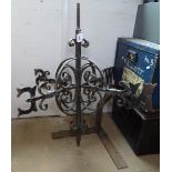 A blacksmith made scrolled wrought-iron weather vane