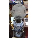 A Continental porcelain oil lamp with chimney and etched shade, 23.5"