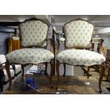 A pair of French stained beech and upholstered open armchairs on cabriole legs