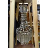 A Vintage 3-tier chandelier with ram's head mounts and faceted lustre drops, in carrying frame,