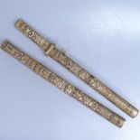 A pair of Chinese bone-handled short swords in carved bone scabbards, 18"