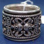 A Chinese pierced and embossed silver ring