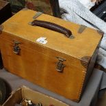 A wooden carrying case with carpentry tools, spirit levels etc