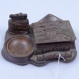 An Oriental patinated metal desk stand, with lighter, 6" across