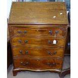 An Edwardian mahogany bureau, with fitted interior above 4 long serpentine-front drawers on