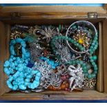 A box containing marcasite brooches, turquoise necklace, stone necklaces etc