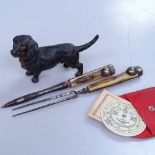 A Negretti and Zambra pocket forecaster, horn-handled implements, and a painted metal Daschund