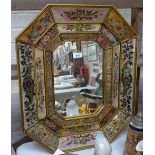 Ornately framed Eastern mirror with glazed painted and gilded panels, height 24.5"