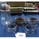 A pair of silver napkin rings, a silver-mounted sugar sifter etc