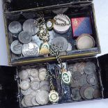 A cash tin with British pre-decimal coinage, including silver, Calcutta Turf Club badges, medallions