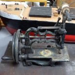 An early sewing machine by James G Weirs of London, height 9"