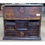 A small 19th century stained pine table-top cabinet, with rising lid and fitted drawers under, W49cm