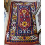 A red ground wool Persian style rug, 140cm x 75cm