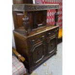 A 1920s carved and panelled oak Court cupboard, W107cm