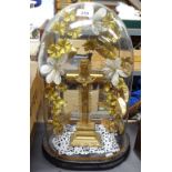 A Victorian glass dome on plinth, with gilded crucifix and artificial flowers, height 20"