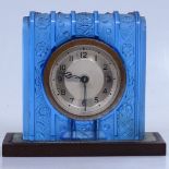 An early 20th century small clock in moulded blue glass case, on Bakelite stand, no. 21599, height