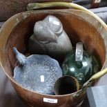 A green overlay glass jug, a small metal bird bath, a soapstone sculpture, horn beakers, and a