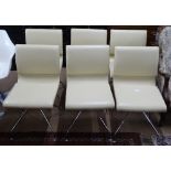 A set of 6 Frag Mustique beige leather swivel dining chairs, on self return 4-star spider base, with