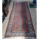 A red ground Turkish runner, 280cm x 95cm