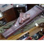 A leather leg of mutton gun case, a leather holster, and a Winchester rifle carrying case