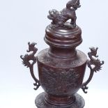 An Antique patinated bronze Chinese urn and cover on stand, height 23.5"