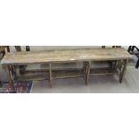 An Ethnic hardwood bench, on stylised supports, L167cm, H47cm, D27cm