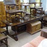 A good quality rectangular oak refectory dining table, with carved frieze, raised on turned