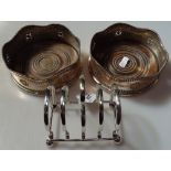 A pair of silver plate on copper wine coasters, and a 4-section toast rack on ball feet