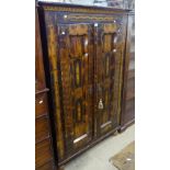 A Continental pine cupboard, with 2 panelled doors, in original painted finish, sitting on bun feet,