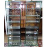 A pair of modern glass open bookshelves on stepped plinth bases, W40cm, H115cm