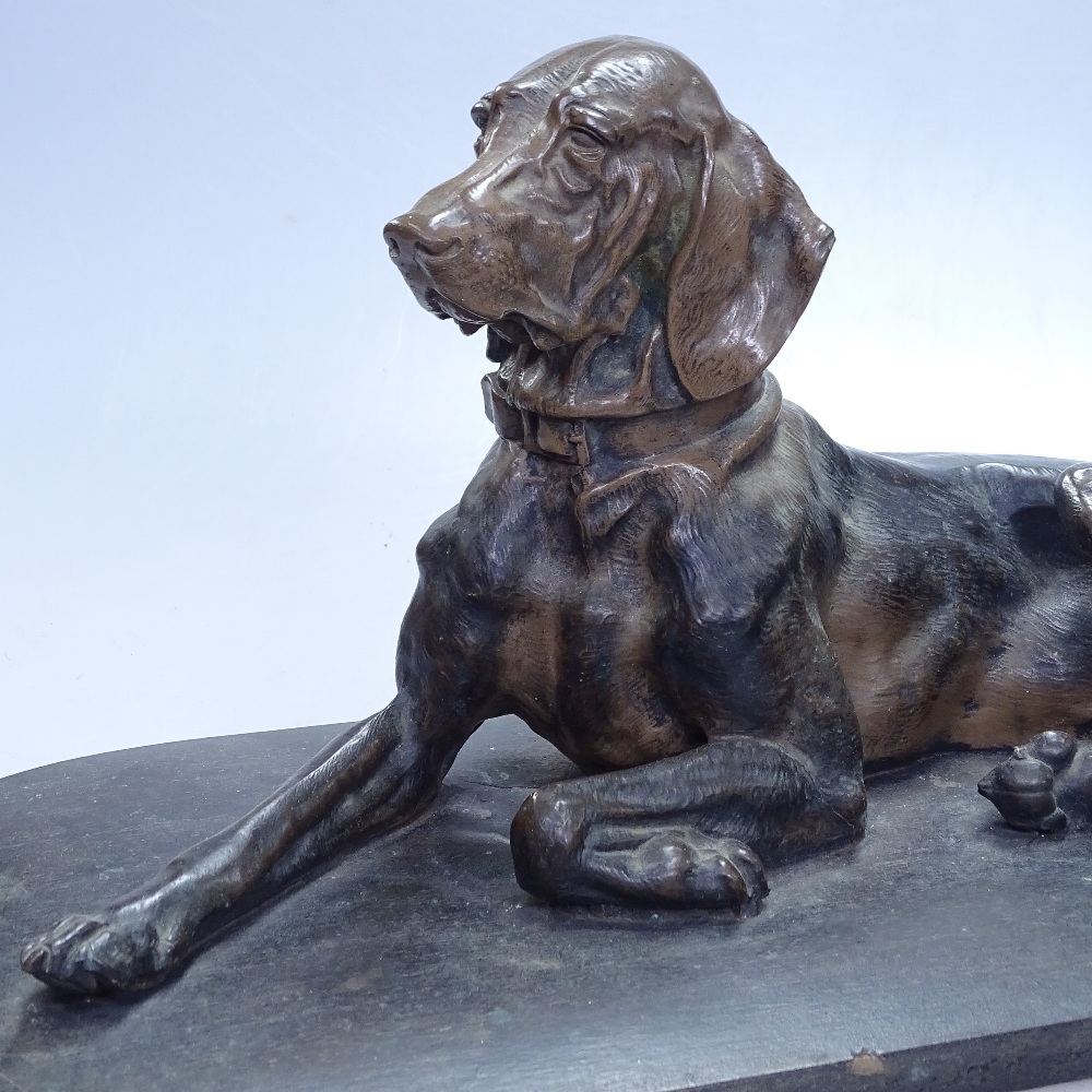 A Vintage patinated spelter hound on wooden plinth, length 16" overall