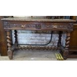 A Victorian oak side table with 2 carved frieze drawers, raised on barley twist legs and