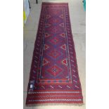 A Meshwani red ground runner, 254cm x 57cm