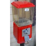 A Vintage red plastic bubblegum dispensing machine, on cast-iron stand, height 54.5"