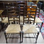 A set of 5 1920s oak ladder back dining chairs, with rush seats, comprising 4 standard and 1 elbow