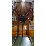 An Edwardian Empire style fluted jardiniere, with brass liner, on cabriole legs, H74cm, W34cm