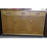 An Ercol oak sideboard, with 3 frieze drawers and cupboards under, L122cm