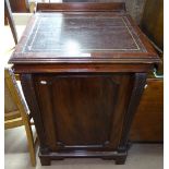 A mahogany clerk's writing desk, with rising lid and carved panelled door, on bracket feet, W63cm