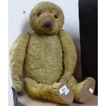 A large Vintage straw-filled teddy bear for restoration, height 25"