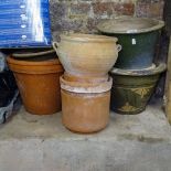 A collection of terracotta and glazed garden plant pots