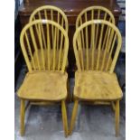 A set of 4 elm-seated Ercol stick-back chairs