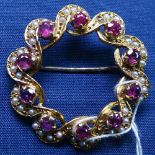 A 9ct gold interwoven brooch, set with seed pearls and rubies, width 30mm