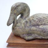 A verdigris bronze duck on fitted wooden stand, length 7.5" overall