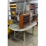 A weathered teak oval extending garden table, together with 2 folding teak garden chairs