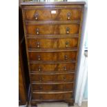 A walnut bow-front narrow chest with 8 short drawers, on bracket feet, W55cm