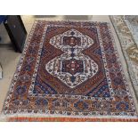 A red ground Afghan design rug, 180cm x 140cm