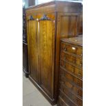 A Victorian mahogany linen press, with 2 carved panelled doors opening to reveal fitted slides and