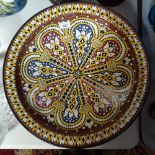 A Middle Eastern painted earthenware dish, 18.5", and a faience plaque